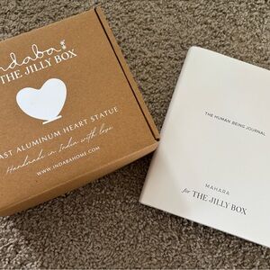 Jilly Box Spring 2025 items (Indaba heart statue and Mahara journal)